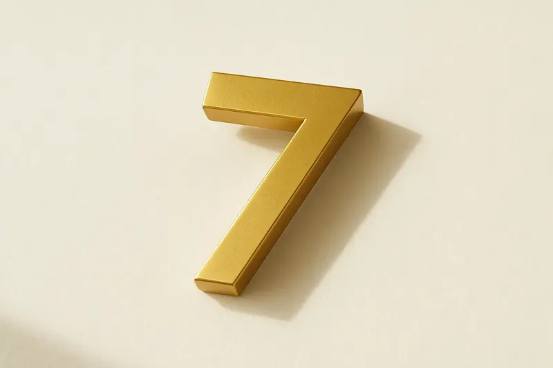 Single large golden seven symbol on cream background with soft shadow
